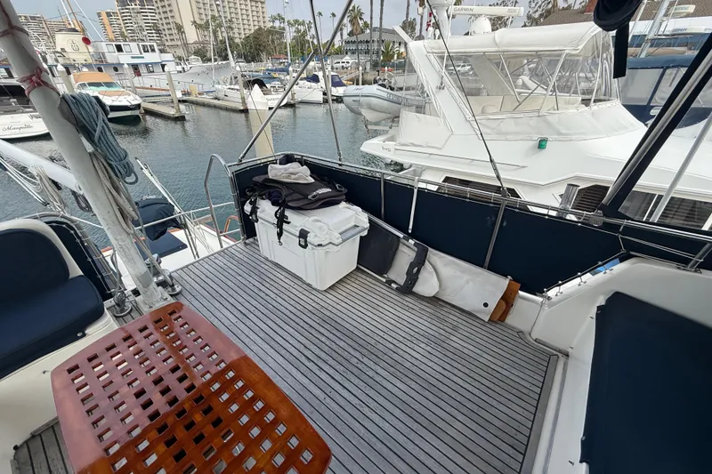 Slide: The Image of Deck of 1992 Grand Banks 46 Classic yacht in marina, featuring seating and storage. - 62