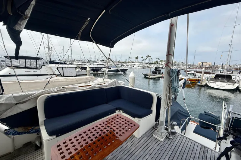 Slide: The Image of 1992 Grand Banks 46 Classic yacht interior with marina view, featuring comfortable seating and nautical decor. - 63