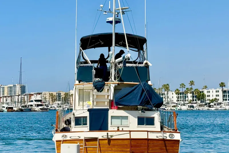 Slide: The Image of 1992 Grand Banks 46 Classic yacht docked in marina with cityscape background. - 7