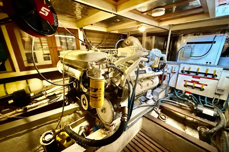 Slide: The Image of Engine room of a 1992 Grand Banks 46 Classic yacht, showcasing mechanical components. - 71
