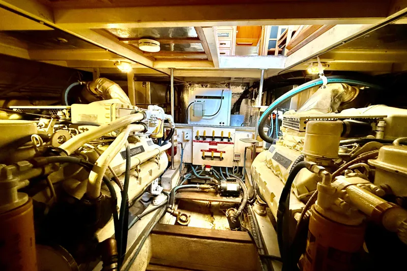 Slide: The Image of Engine room of a 1992 Grand Banks 46 Classic yacht, showcasing machinery and control panels. - 73