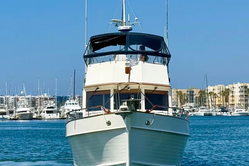 Slide: The Image of 1992 Grand Banks 46 Classic yacht docked in a marina, clear blue sky background. - 8