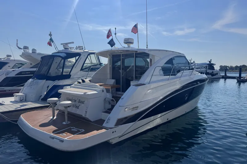 The Image of 2012 Cruisers Yachts 41 Cantius docked in a marina under clear skies. - 3