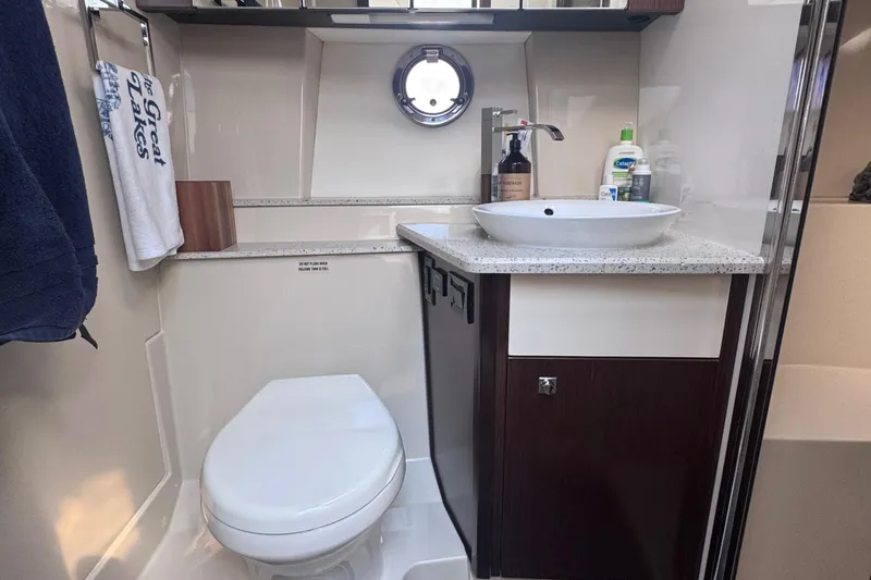 Slide: The Image of Luxurious bathroom in 2012 Cruisers Yachts 41 Cantius with modern fixtures and porthole window. - 35
