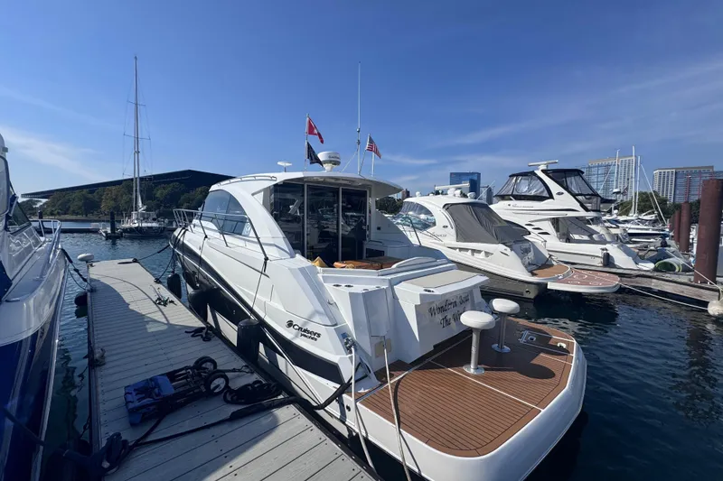 Slide: The Image of 2012 Cruisers Yachts 41 Cantius docked at marina under clear blue sky. - 4