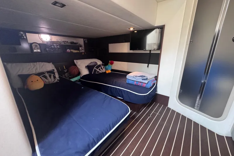 Slide: The Image of 2012 Cruisers Yachts 41 Cantius cabin with twin beds, modern decor, and striped flooring. - 46