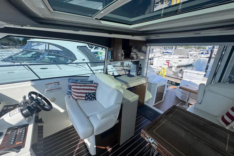 Slide: The Image of Interior of 2012 Cruisers Yachts 41 Cantius with white seating and marina view. - 8