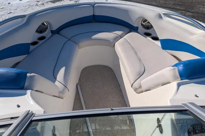 Slide: The Image of 2012 Rinker 216 Captiva Bowrider interior with blue and white seating. - 12
