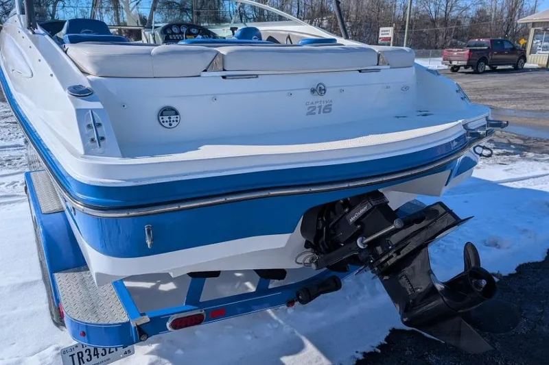 Slide: The Image of 2012 Rinker 216 Captiva Bowrider on trailer, rear view in snowy setting. - 3