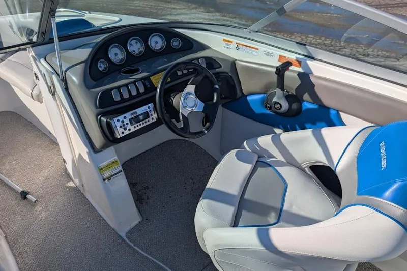 Slide: The Image of 2012 Rinker 216 Captiva Bowrider cockpit with steering wheel and control panel. - 5