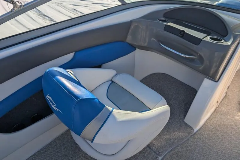 Slide: The Image of 2012 Rinker 216 Captiva Bowrider interior with blue and white seating. - 6