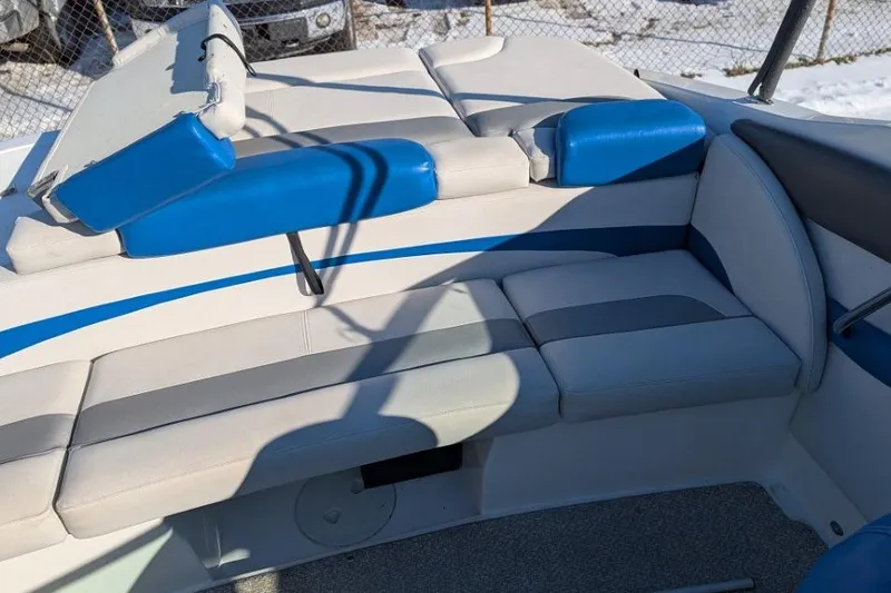 Slide: The Image of 2012 Rinker 216 Captiva Bowrider interior with blue and gray seating. - 7