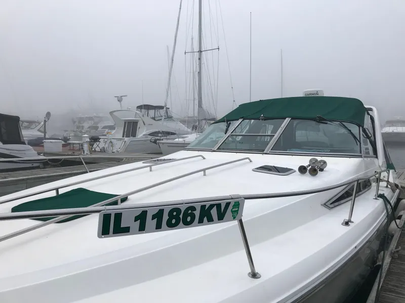 Slide: The Image of 1991 Sea Ray 310/330 Sundancer docked in a foggy marina. - 10