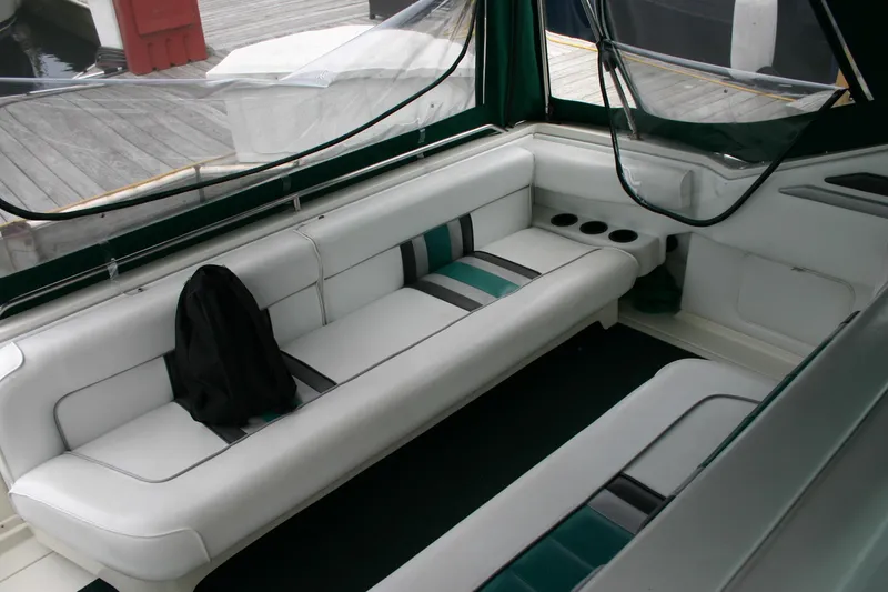 Slide: The Image of Interior of a 1991 Sea Ray 310/330 Sundancer boat with white seating and green accents. - 14