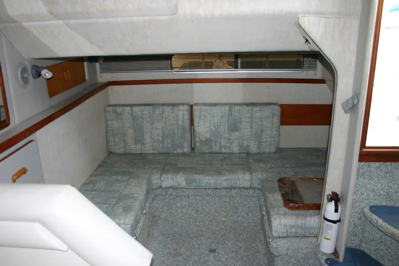 Slide: The Image of Interior of 1991 Sea Ray 310/330 Sundancer with cushioned seating and fire extinguisher. - 17