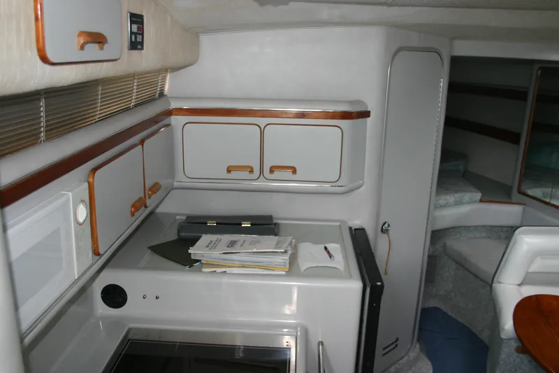 Slide: The Image of Interior of 1991 Sea Ray 310/330 Sundancer with cabinets and seating area. - 18