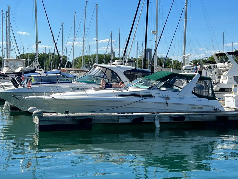 Slide: The Image of 1991 Sea Ray 310/330 Sundancer docked at marina, sunny day, calm water. - 7
