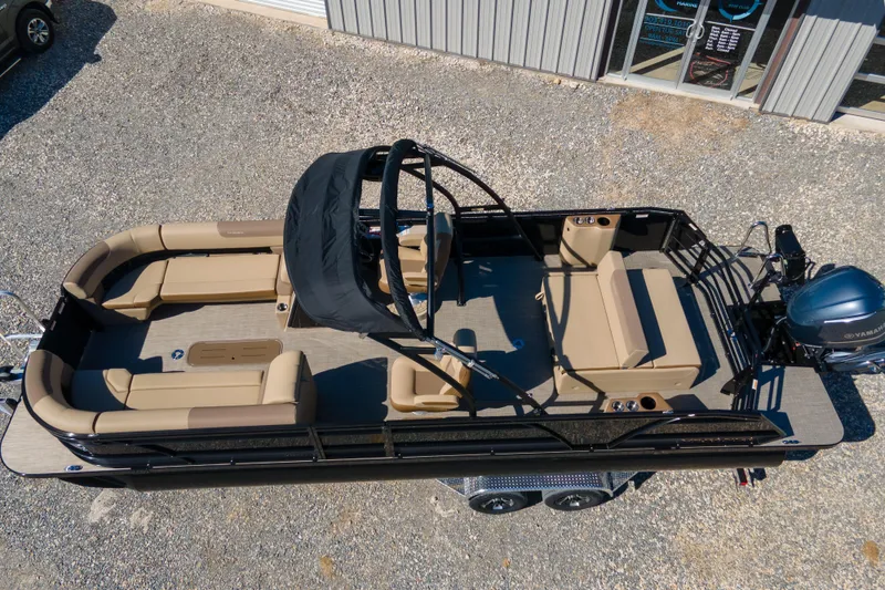 Slide: The Image of 2026 Veranda VR 265 VLI pontoon boat with beige seating and black canopy. - 2