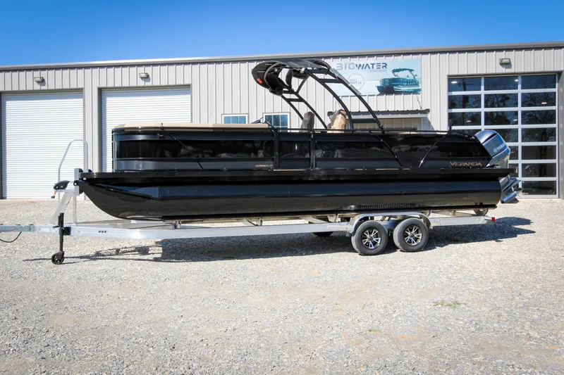 Slide: The Image of 2026 Veranda VR 265 VLI pontoon boat on trailer, parked outside a garage. - 5