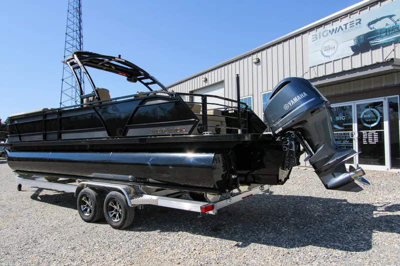 Slide: The Image of 2026 Veranda VR 265 VLI pontoon boat with Yamaha engine on trailer outside dealership. - 9