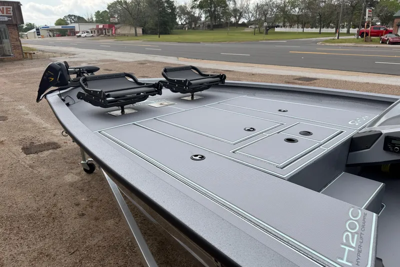 Slide: The Image of 2026 Xpress H20C Crappie boat with sleek deck design, parked roadside. - 2