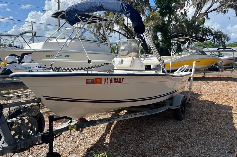 Slide: The Image of 2005 Cape Craft 16 CC boat on trailer, parked outdoors under blue sky. - 7