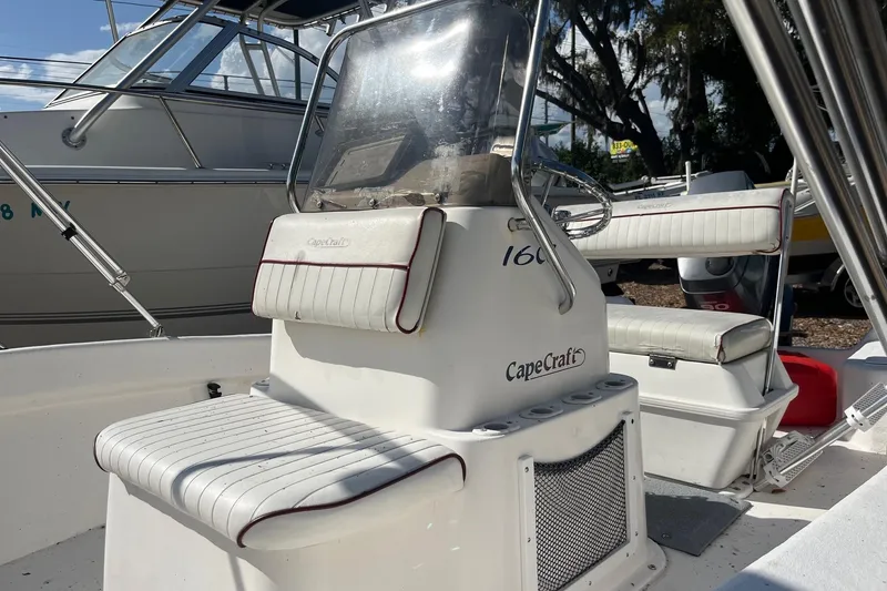 Slide: The Image of 2005 Cape Craft 16 CC boat interior with seating and console, in a marina setting. - 8