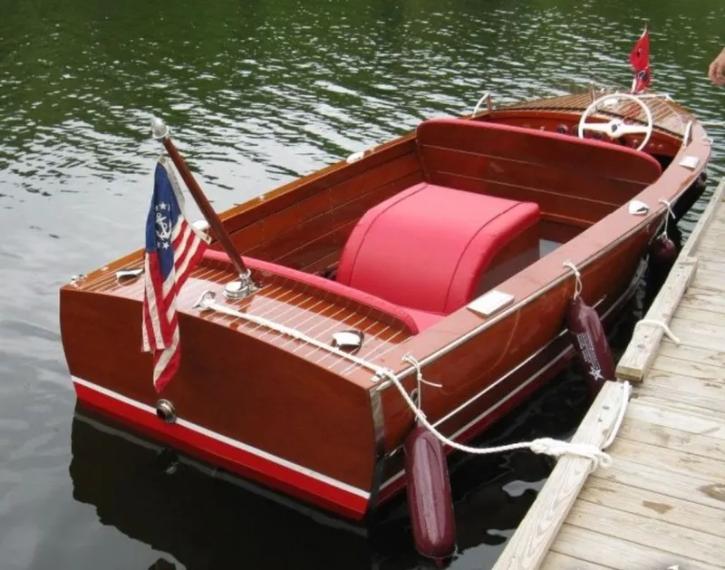 Slide: The Image of 1967 Chris-Craft 17 Deluxe boat docked with red interior. - 1