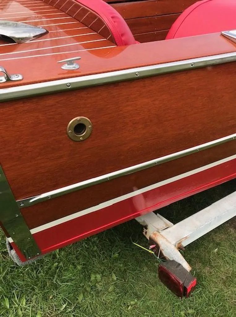 Slide: The Image of 1967 Chris-Craft 17 Deluxe boat with wooden finish on trailer. - 6