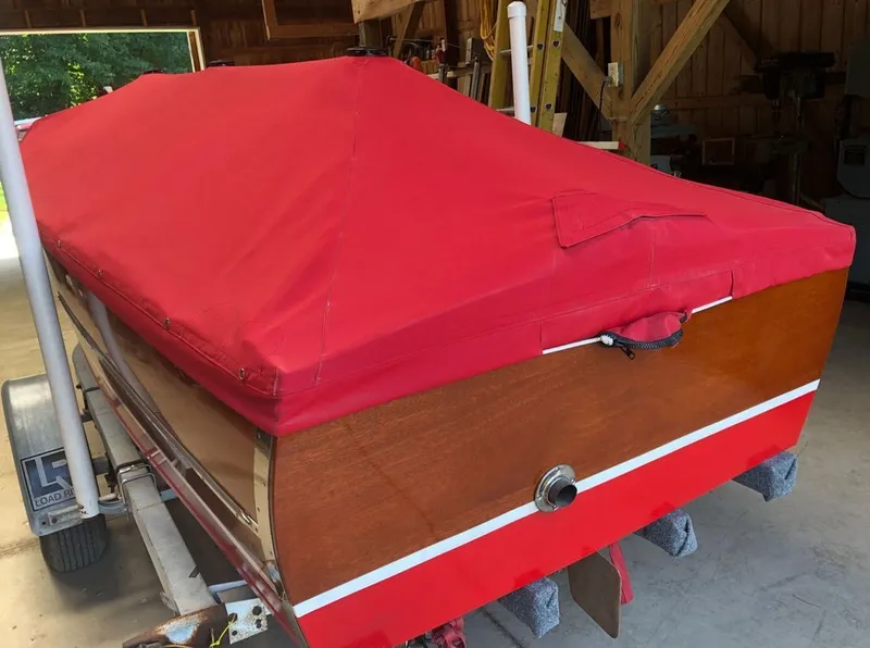 Slide: The Image of 1967 Chris-Craft 17 Deluxe boat with red cover in garage. - 8