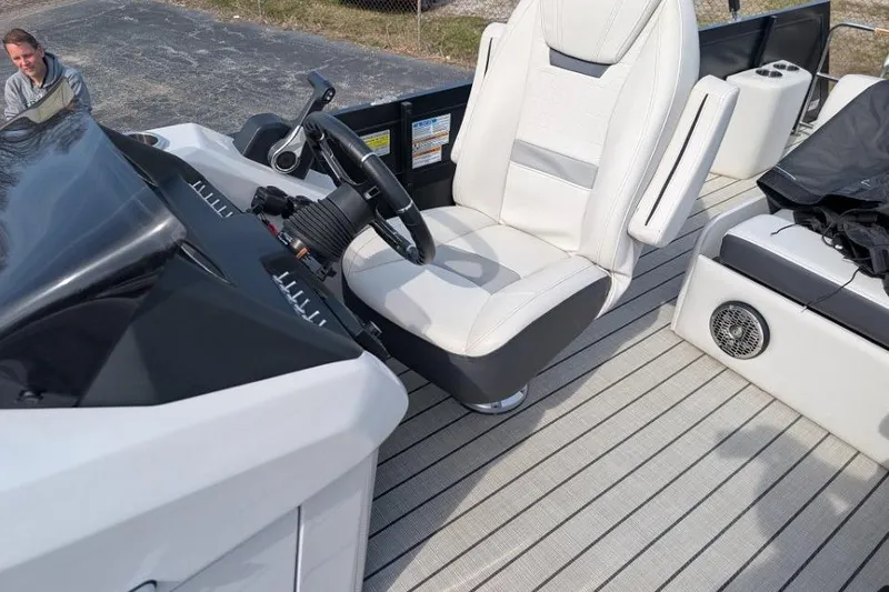 Slide: The Image of 2022 Viaggio 23 S boat interior with white captain's chair and steering wheel. - 8
