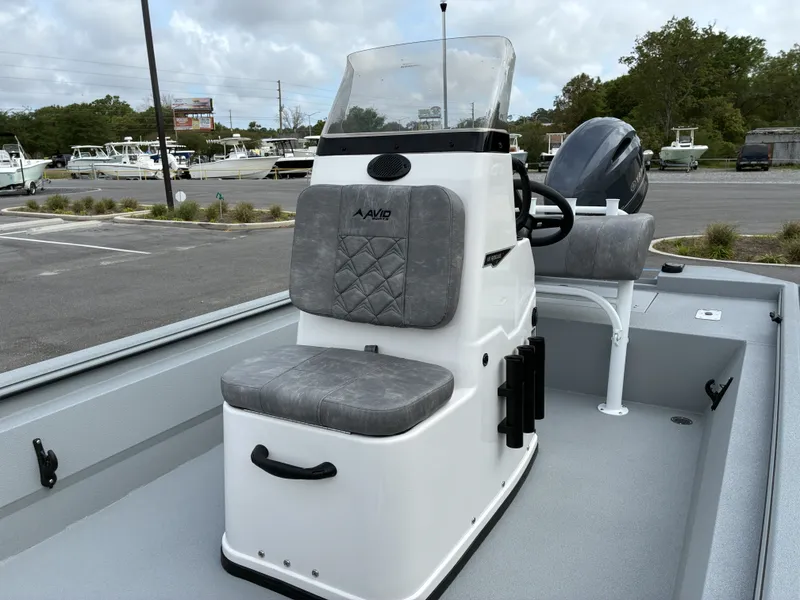 Slide: The Image of Avid 18CC ROGUE 2026 boat with gray seats at the marina. - 8