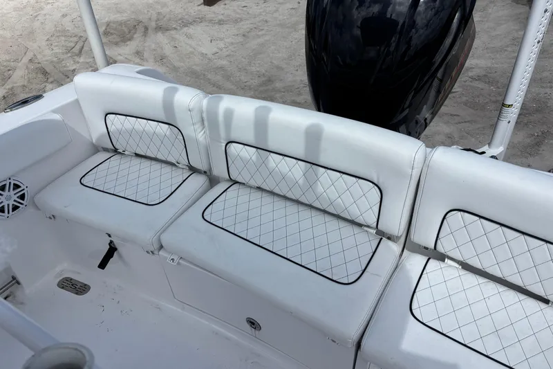 Slide: The Image of 2022 Sportsman Heritage 231 Center Console boat with white cushioned seating and diamond stitching. - 13
