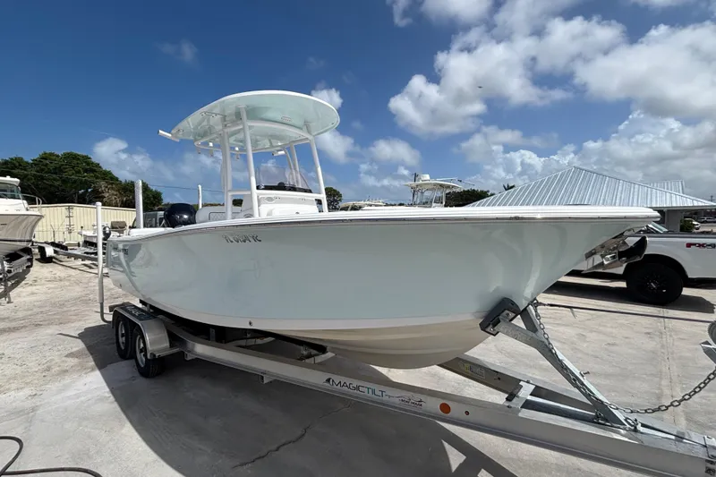 Slide: The Image of 2022 Sportsman Heritage 231 Center Console boat on trailer under blue sky. - 3