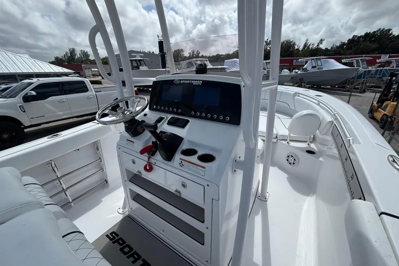 Slide: The Image of 2022 Sportsman Heritage 231 Center Console boat interior with steering wheel and control panel. - 5