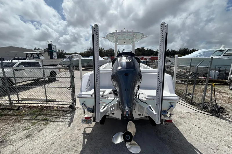 Slide: The Image of 2022 Sportsman Heritage 231 Center Console boat with outboard motor in a marina setting. - 9