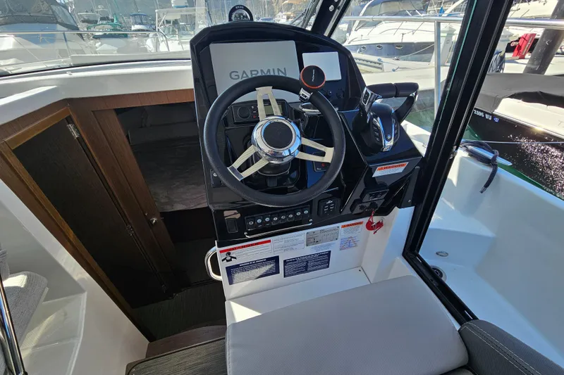 Slide: The Image of 2023 Jeanneau NC Weekender 895 helm with Garmin navigation system and modern controls. - 14