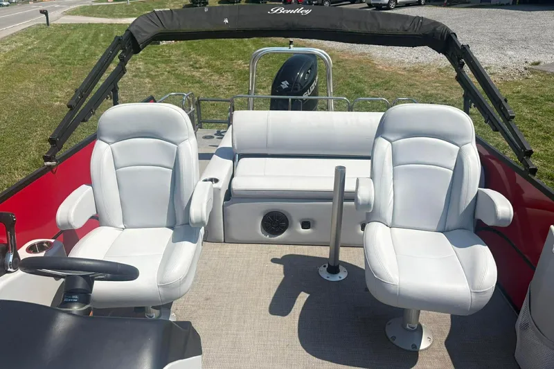 Slide: The Image of 2023 Bentley Pontoons Legacy 223 SB interior with white seating and steering wheel. - 5