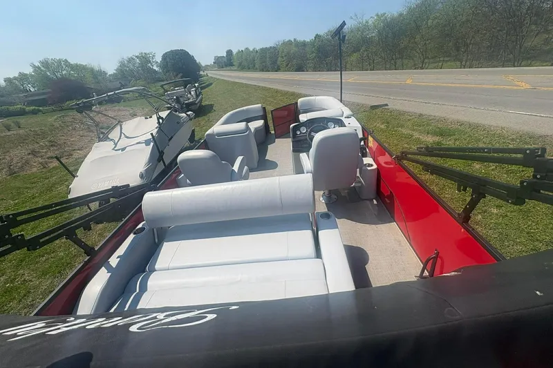 Slide: The Image of 2023 Bentley Pontoons Legacy 223 SB with spacious seating, parked near a road. - 6