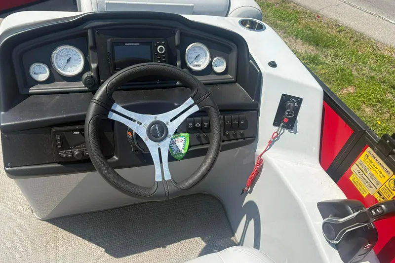 Slide: The Image of 2023 Bentley Pontoons Legacy 223 SB dashboard with steering wheel and controls. - 8