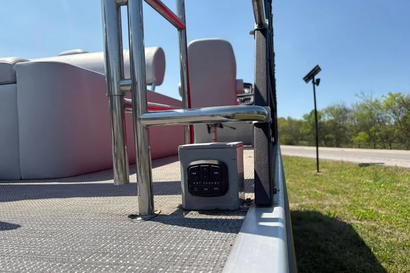 Slide: The Image of 2023 Bentley Pontoons Legacy 223 SB deck with railing and control panel. - 9