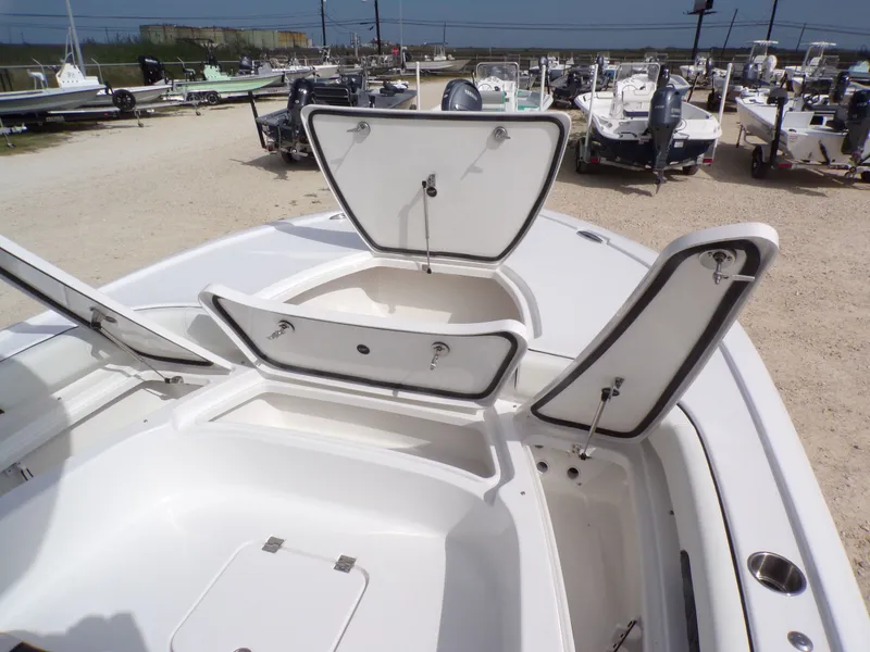 Slide: The Image of 2026 Tidewater 2500 Carolina Bay with open storage compartments at the marina. - 23