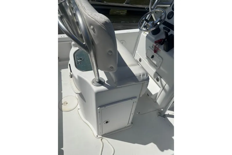 Slide: The Image of 2015 Sea Hunt BX 22 Pro boat interior with steering wheel and seating. - 11