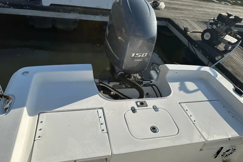 Slide: The Image of 2015 Sea Hunt BX 22 Pro boat with Yamaha 150 engine at dock. - 12