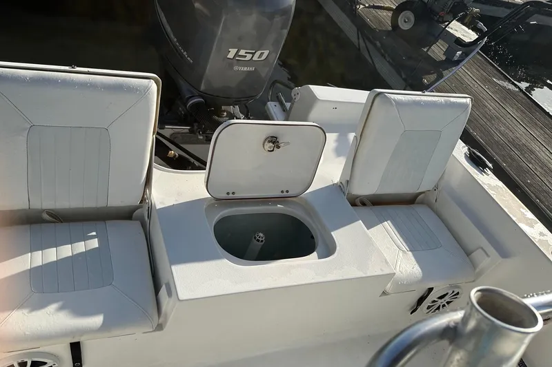 Slide: The Image of 2015 Sea Hunt BX 22 Pro boat interior with Yamaha 150 engine, featuring seating and storage. - 14