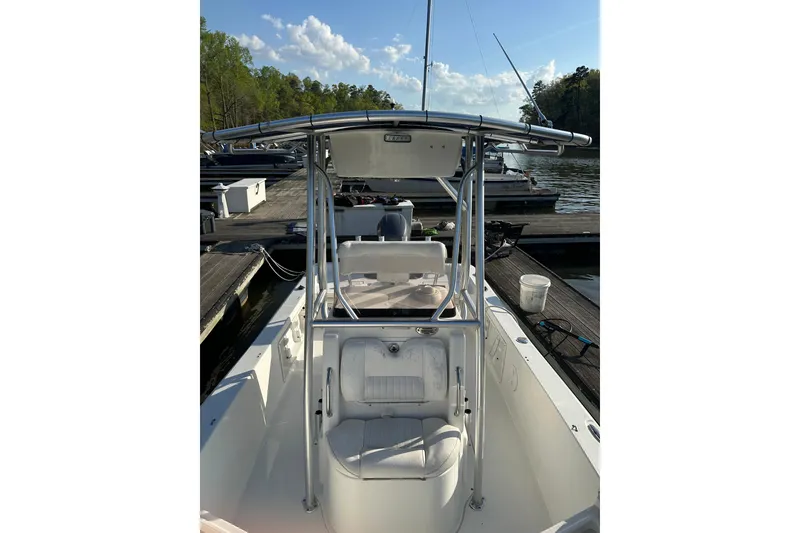 Slide: The Image of 2015 Sea Hunt BX 22 Pro boat docked, featuring center console and T-top. - 4