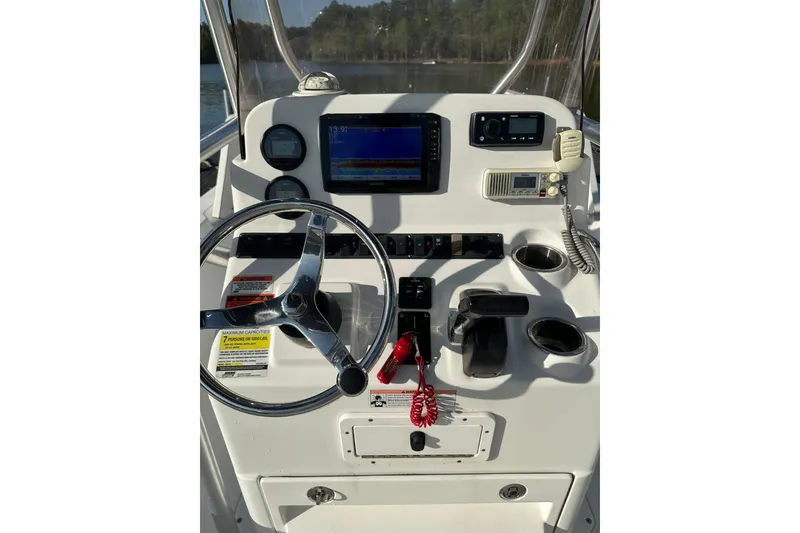 Slide: The Image of 2015 Sea Hunt BX 22 Pro boat console with steering wheel and navigation equipment. - 8