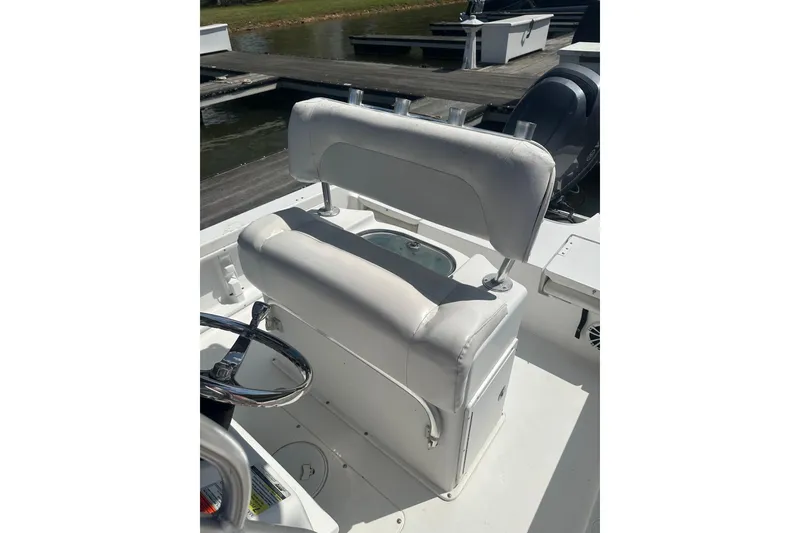 Slide: The Image of 2015 Sea Hunt BX 22 Pro boat interior with white seating and steering wheel. - 9