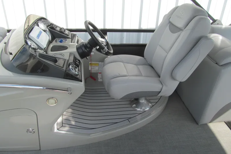 Slide: The Image of Captain's seat and helm of 2017 Regency 220 LE3 boat, featuring modern controls. - 13