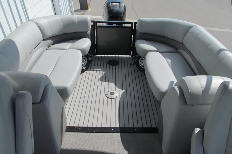 Slide: The Image of 2017 Regency 220 LE3 pontoon boat interior with gray seating and spacious deck. - 14
